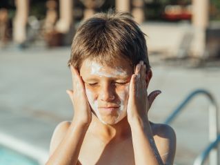 A Boy with Sunscreen on His Face